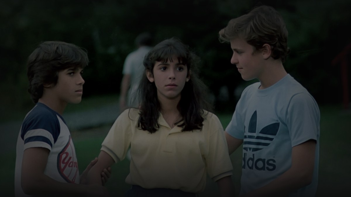 Still from Sleepaway Camp (1983) — TMDB backdrop, pre-darkened 0.85, baked at factor 0.45 (baked mean 30.7)